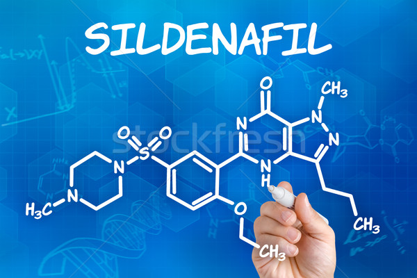 Hand with pen drawing the chemical formula of sildenafil Stock photo © Zerbor