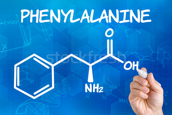 Hand with pen drawing the chemical formula of phenylalanine Stock photo © Zerbor