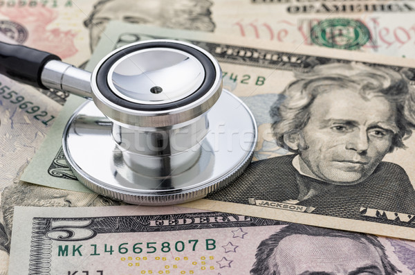 Close-up of a stethoscope on dollar bills Stock photo © Zerbor