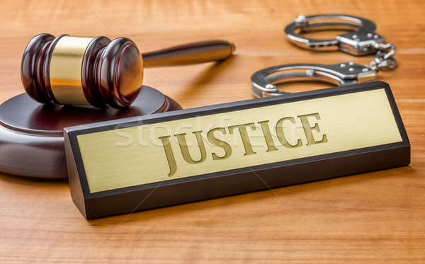 A gavel and a name plate with the engraving Justice Stock photo © Zerbor