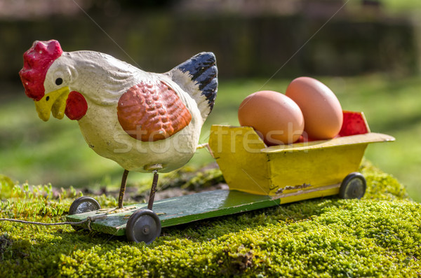 Antique papier mâché rooster on a cart with eggs Stock photo © Zerbor