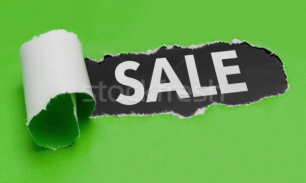 Torn green paper revealing the word Sale Stock photo © Zerbor