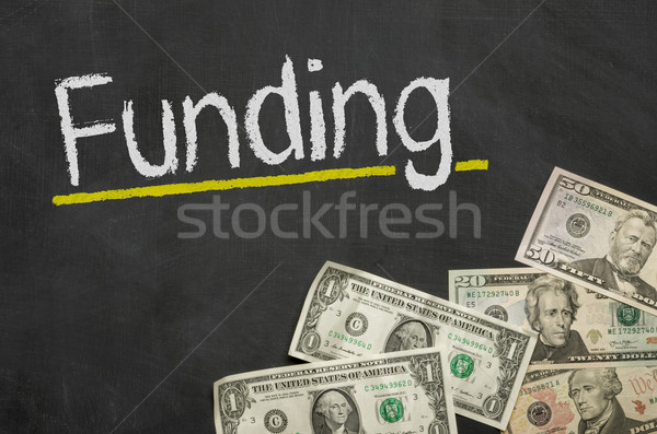 Text on blackboard with money - Funding Stock photo © Zerbor