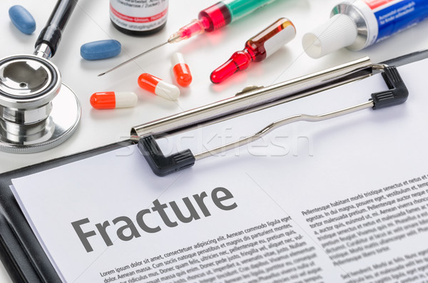 The diagnosis Fracture written on a clipboard Stock photo © Zerbor