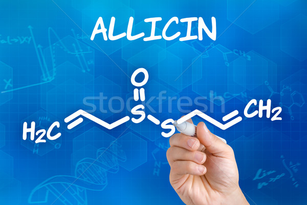Hand with pen drawing the chemical formula of Allicin Stock photo © Zerbor