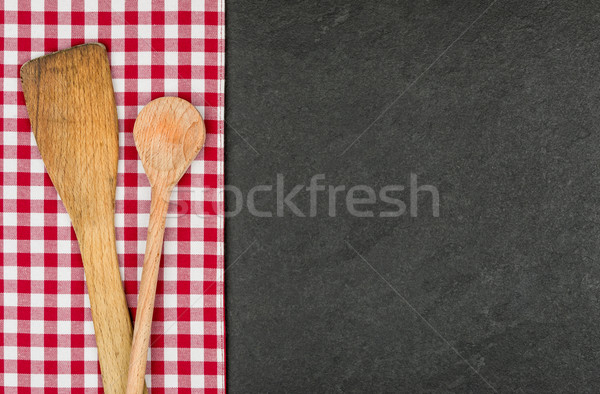 Wooden spoon on a slate plate with a red checkered tablecloth Stock photo © Zerbor