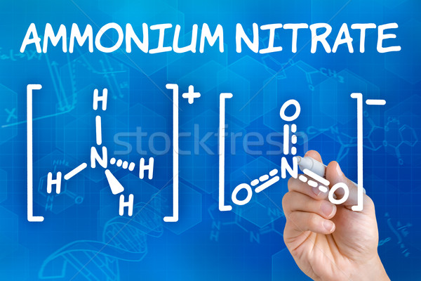 Hand with pen drawing the chemical formula of ammonium nitrate Stock photo © Zerbor