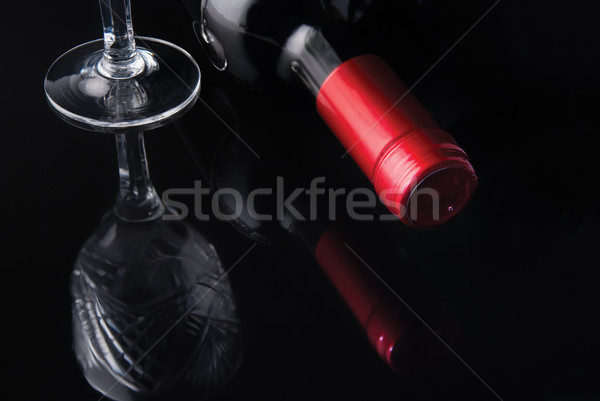 bottle of wine and a glass on a black background Stock photo © Zhukow