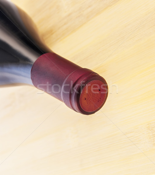 Red wine bottle on wooden table background Stock photo © Zhukow