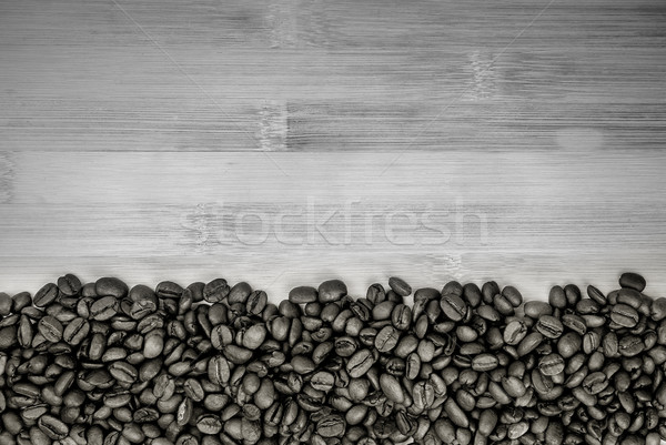 A pile of coffee beans forming a simple stripe frame Stock photo © Zhukow
