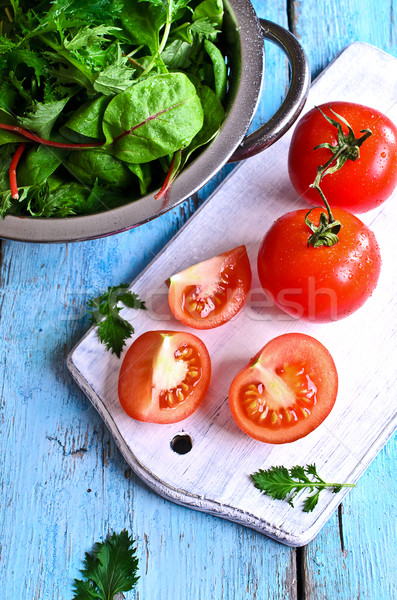 Tomatoes and green lettuce Stock photo © zia_shusha