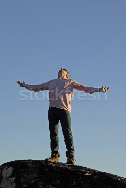 Prier jeune homme bras large ouvrir ciel [[stock_photo]] © zittto