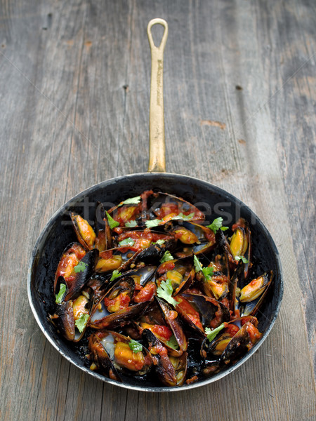 rustic black mussel in tomato sauce Stock photo © zkruger