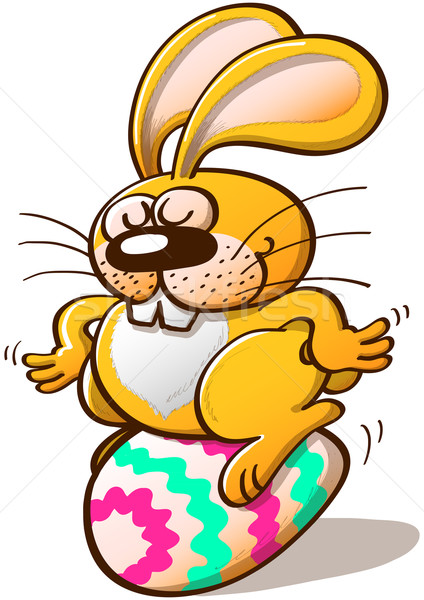 Bunny Sitting on an Easter Egg Stock photo © zooco