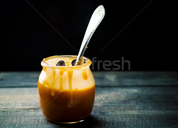Stock photo: butter caramel in a glass jar