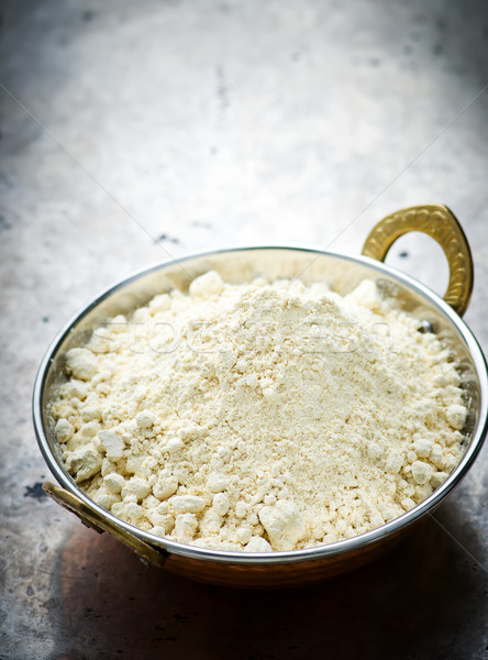 Stock photo: Flour from chick-pea in the Indian copper bowl 