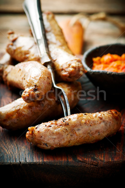 Merguez Sausages with harissa on wooden board Stock photo © zoryanchik