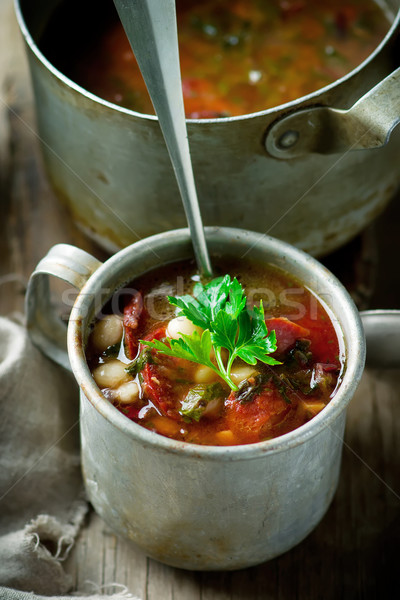 Sopa de feijão salsichas metal caneca estilo rústico Foto stock © zoryanchik