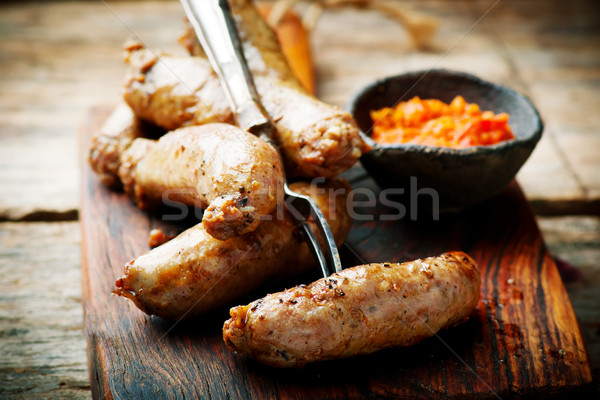 Merguez Sausages with harissa on wooden board Stock photo © zoryanchik