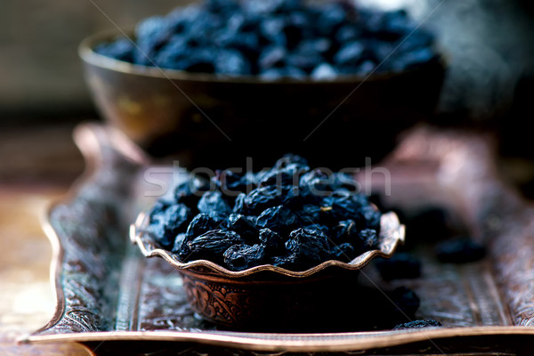 dried dark raisin in oriental metal ware Stock photo © zoryanchik