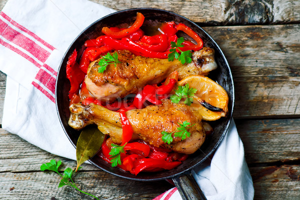 chicken drumsticks with a pepper  in a frying pan. Stock photo © zoryanchik