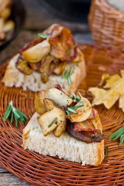 Fried cepes with bacon, garlic and rosemary Stock photo © zoryanchik