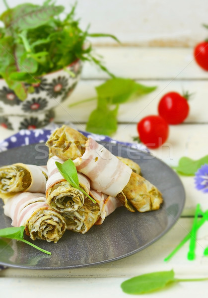 Rolls from an omelet with a sorrel and bacon Stock photo © zoryanchik