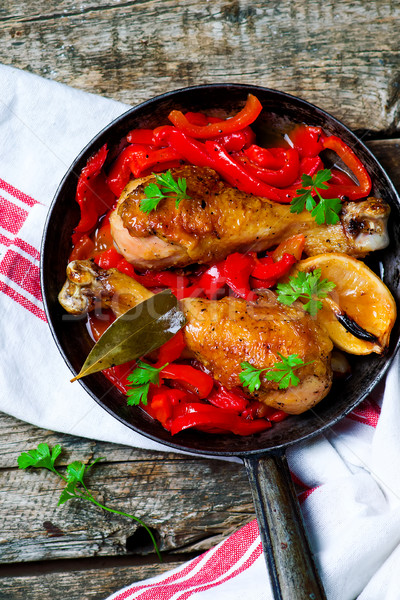 chicken drumsticks with a pepper  in a frying pan. Stock photo © zoryanchik