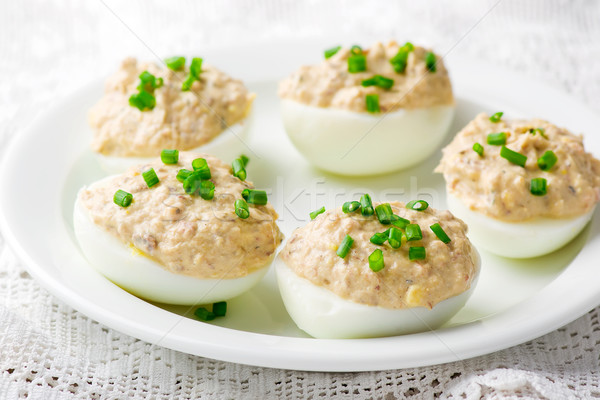 Stock photo:  delicious stuffed eggs on white plate. 