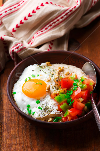 Savory Oatmeal with Cheddar and Fried Egg Stock photo © zoryanchik