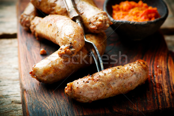 Merguez Sausages with harissa on wooden board Stock photo © zoryanchik