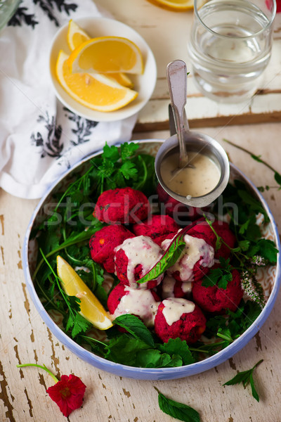  Beet falafel with tahina sauce and green salad  Stock photo © zoryanchik