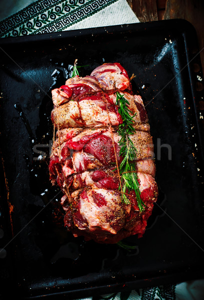 Crude lamb leg for roasting on a baking sheet.  Stock photo © zoryanchik