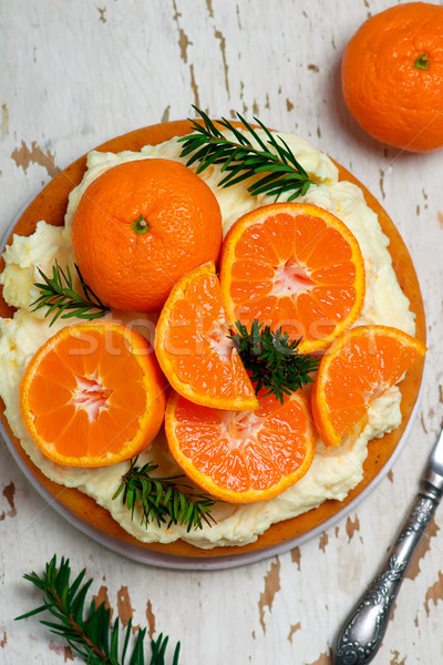 Stock photo: fresh tangerine cake with cream cheese frosting.