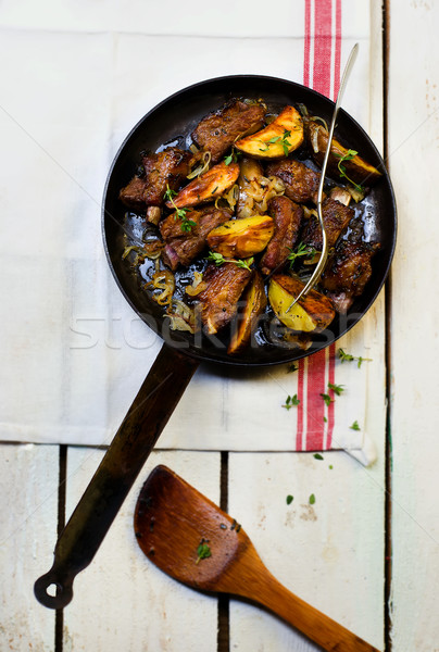 Stock photo: ribs fried with potato on a frying pan