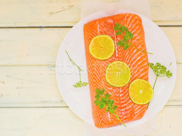 fresh, crude fillet of a salmon with slices of a lime and greens  Stock photo © zoryanchik