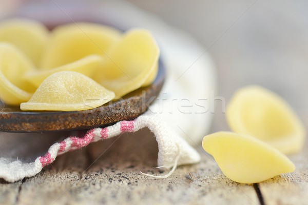 Stock photo: 	dry pasta on wooden table