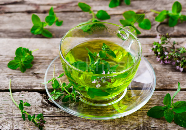 Gyógynövény tea organikus gyógynövények üveg csésze fa asztal Stock fotó © zoryanchik