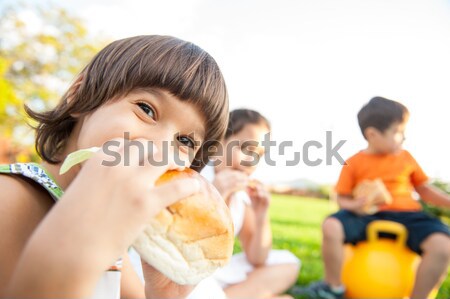 Three kids eating burgers Stock photo © zurijeta