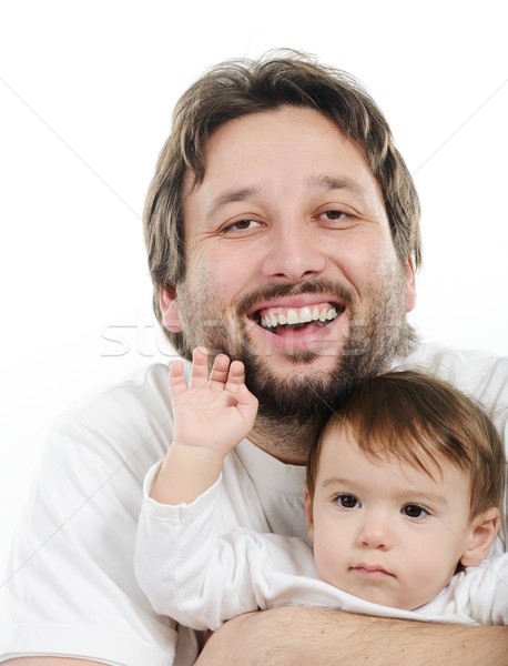 Stock photo: Happy young man holding a smiling 4-5 months old baby, isolated 