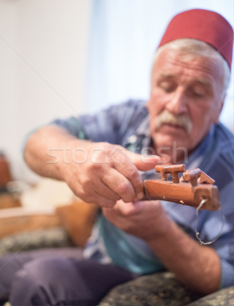 Elderly man with traditional hat playing old type guitar Stock photo © zurijeta
