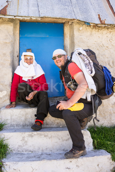 Hiker backpacker talking to old woman on mountain Stock photo © zurijeta