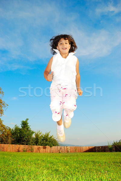Little girl saltando belo céu menina esportes Foto stock © zurijeta