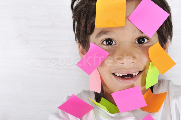 Little boy with memo notes on his face Stock photo © zurijeta