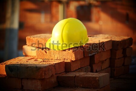 Under construction, helmet and bricks for building site Stock photo © zurijeta