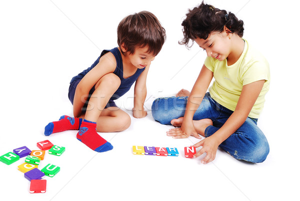 Stock photo: Children playing with cubes in white isolated space