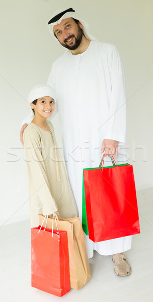 Happy Arabic father and son having fun time with shopping bags Stock photo © zurijeta