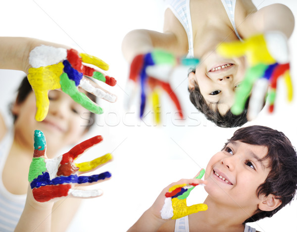 Stock photo: Little boy with hands painted in colorful paints ready for hand 