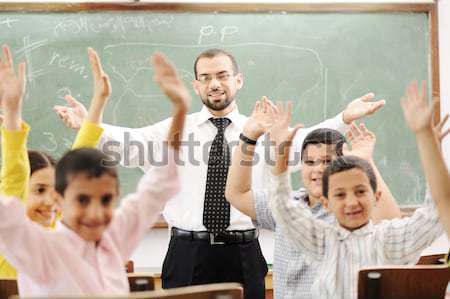 Good teacher in classroom in front of the board Stock photo © zurijeta