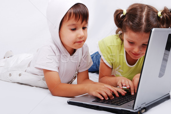 Cute couple of children are playing and learning on laptop Stock photo © zurijeta
